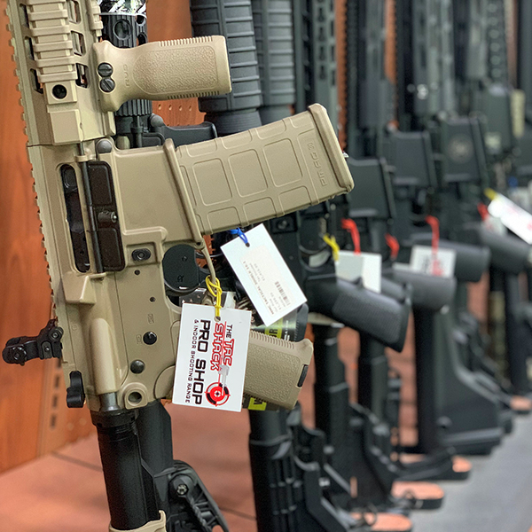 Semi automatic rifles lined up in gun store with pro shop tag